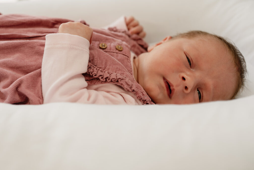 A peaceful close-up of a newborn resting in a bassinet during a relaxed, at-home lifestyle session in Nottingham. Captured in soft natural light to reflect the quiet beauty of early days.

